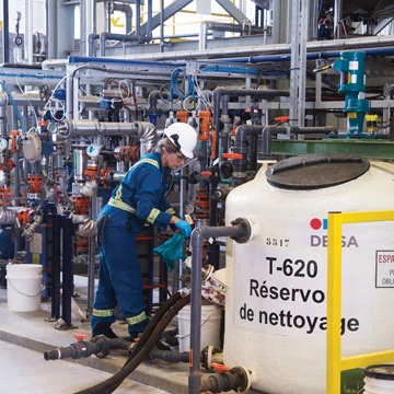 An operator taking samples from a wastewater treatment unit